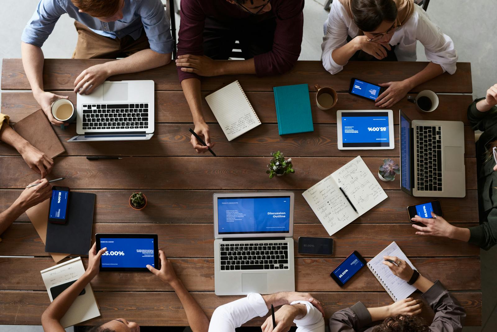 Small team collaborating on a laptop during an online course strategy session
